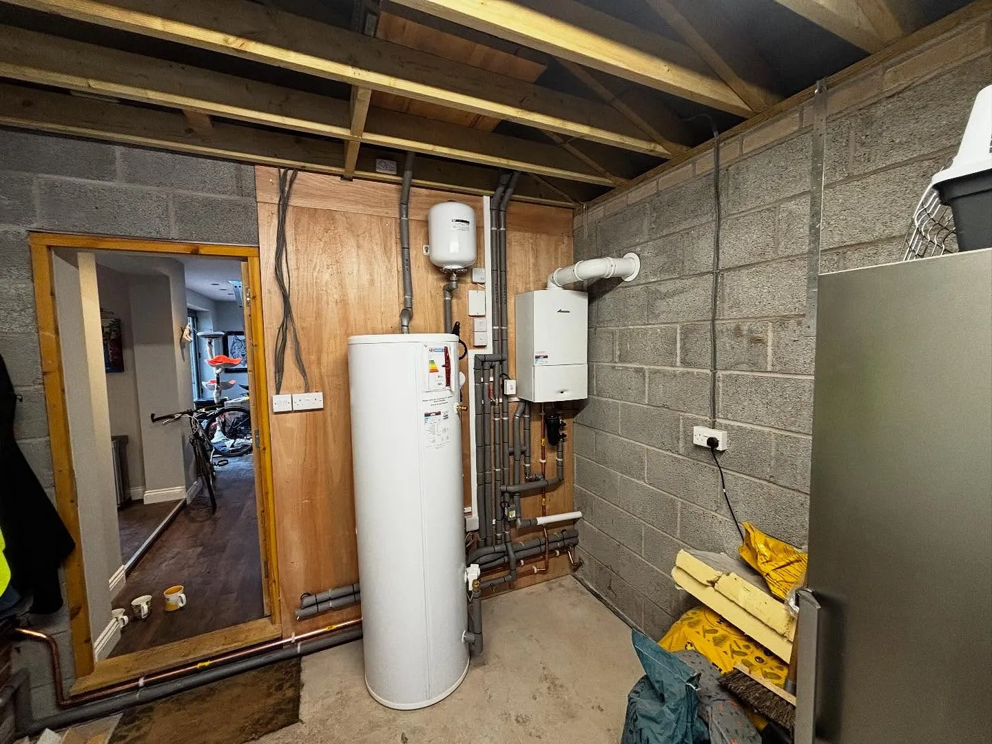 Boiler and hot water cylinder installed by AMW Heating in a garage